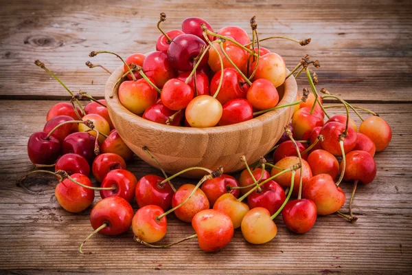 Rainier Cherries in a bowl on wooden background — Stock Photo, Image