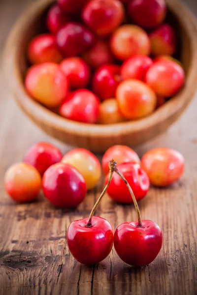 Rainier Cherries in a bowl on wooden background — Stock Photo, Image