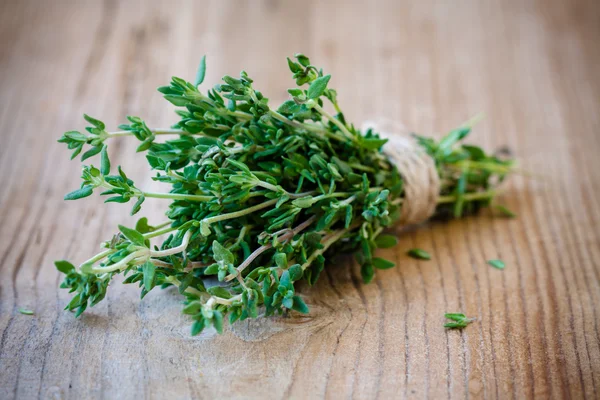 Bunch of fresh thyme on a wooden background — Stock Photo, Image