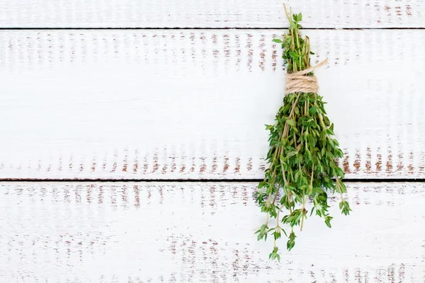 Bunch of thyme on a white wooden background — Stock Photo, Image