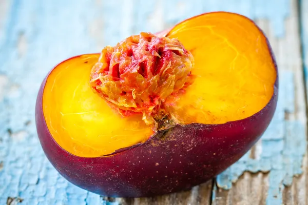 Fresh organic flat nectarines on an old wooden background — Stock Photo, Image