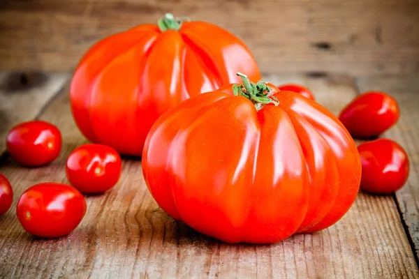 Färska röda heirloom tomater på en trä bakgrund — Stockfoto