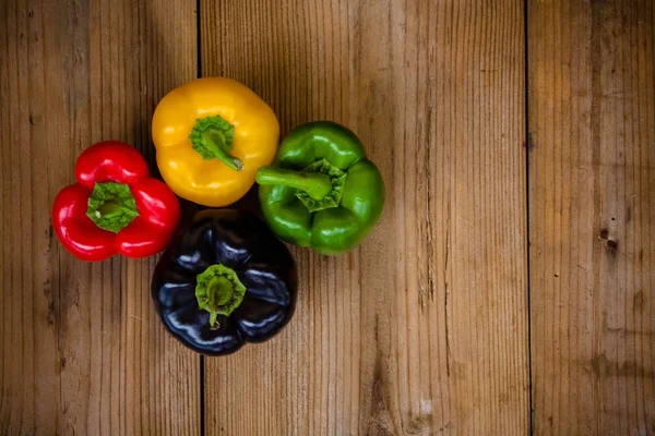 Red, green, black and yellow bell peppers