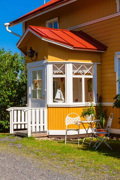 Wooden yellow house with red roof in Scandinavian style — Stock Photo, Image