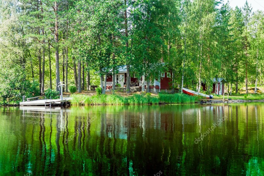 Old Finnish summer cottage at a lake — Stock Photo © nblxer #51374259