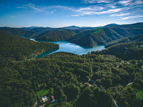 Aerial view of blue lakes and and hills with green forests in Plitvice Lakes National Park in Croatia