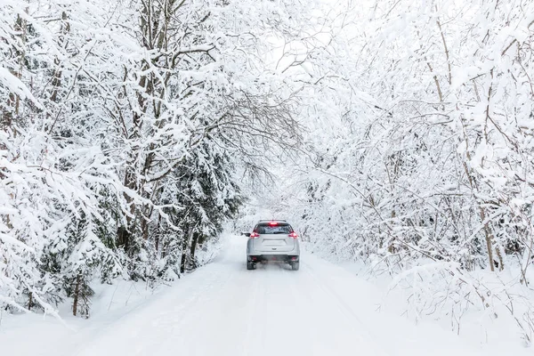 在雪地覆盖的森林里的一条冬季公路上开车 冬天的风景 路上有车 树上覆盖着雪 — 图库照片