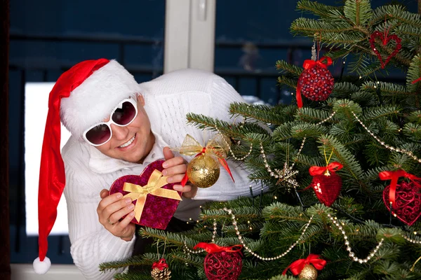Beautiful young man in Santa Claus clothes — Stock Photo, Image