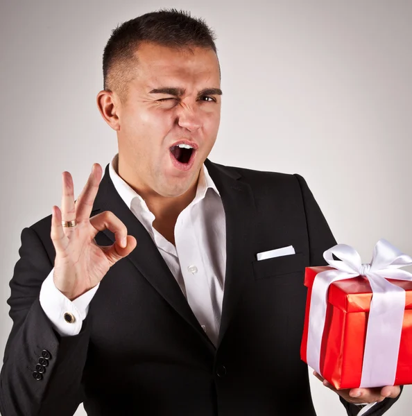 Elegant young man with present — Stock Photo, Image