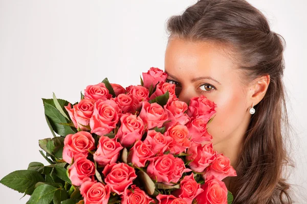 Beautiful woman with a bouquet of roses Stock Picture
