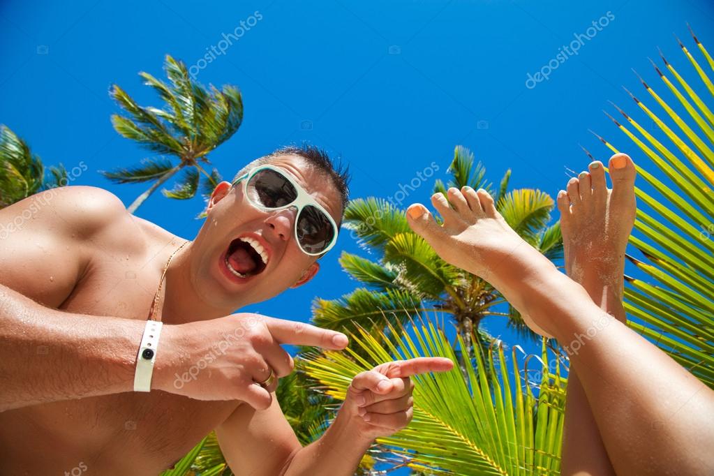 Funny smiling man on the beach Stock Photo by ©AbElenaa 47415075