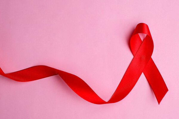 Hands holding red ribbon, hiv awareness concept, world AIDS day, world hypertension day