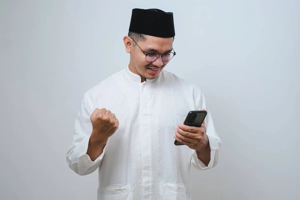 Ásia Muçulmano Homem Segurando Smartphone Fazendo Ganhando Gesto Segurando Celular — Fotografia de Stock