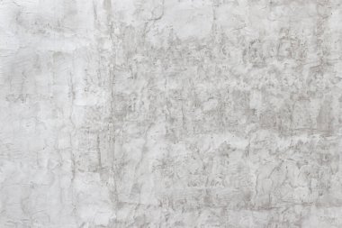 Yıkık dökük alçılı eski bir evin eski püskü duvarı. Sarı-gri soyut doku.