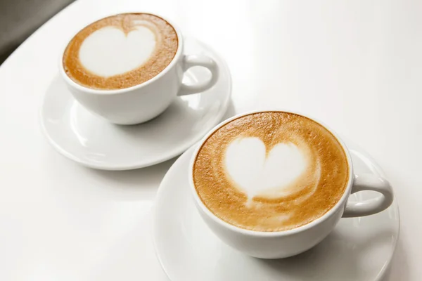 Two cups of coffee with latte art — Stock Photo, Image