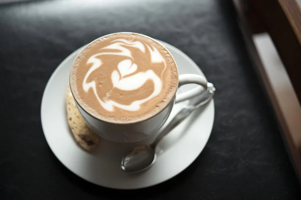 Hot mocha with latte art on black table — Stock Photo, Image