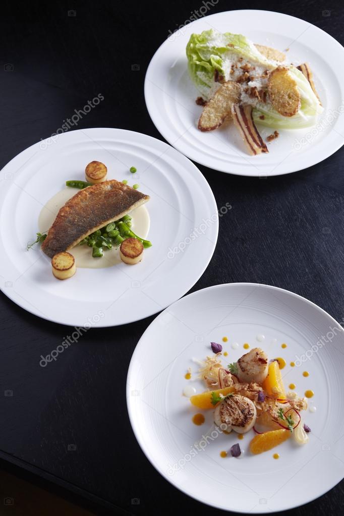 Three plates of food on table
