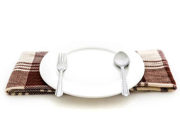 Dining place setting. A white plate with silver fork and spoon — Stock Photo, Image