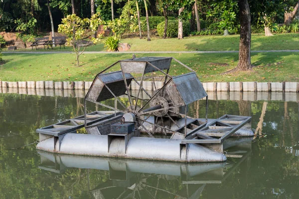 Water wheel floating on the canal of park — Stock Photo, Image