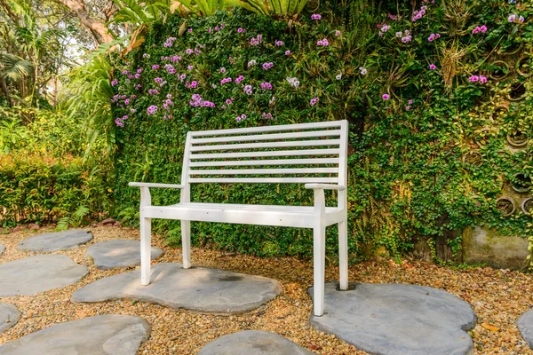 Bílá lavice na zahradu a greenleaves zdi — Stock fotografie