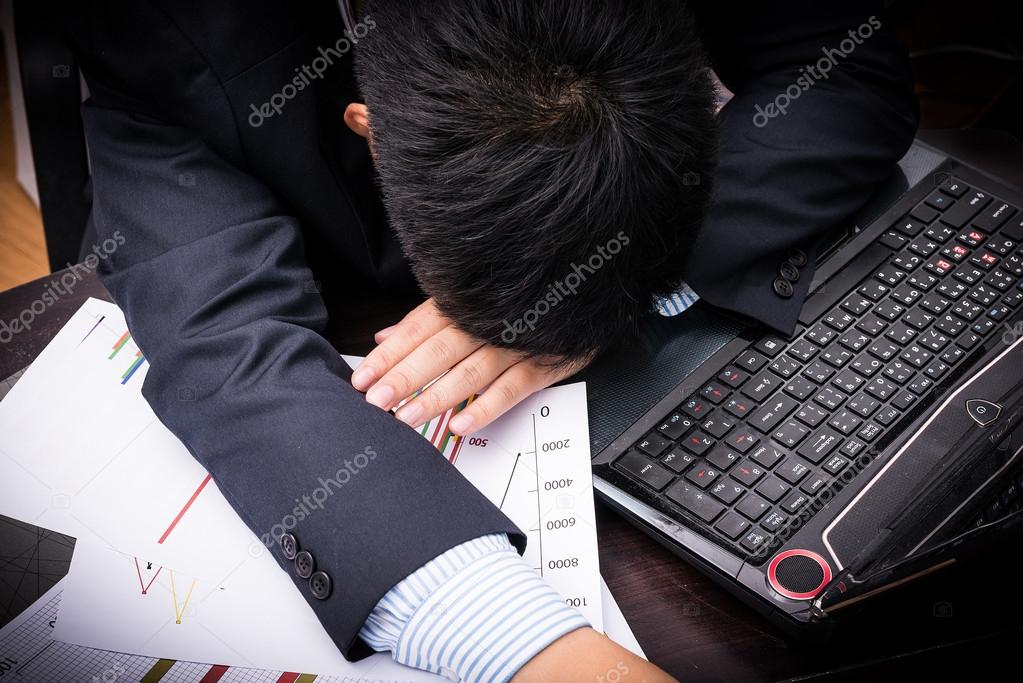 Exhausted and tired businessman sleeping in office