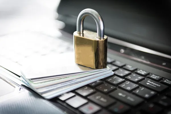 Padlock and credit cards on top of laptop — Stock Photo, Image