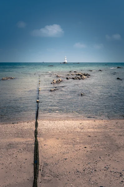 Buoys and Lighthouse on the stone and sea — Stock Photo, Image