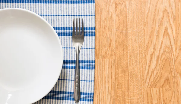 White plate and silver fork — Stock Photo, Image