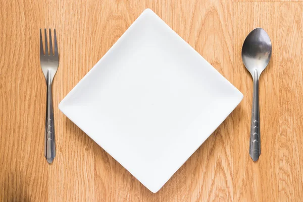 Empty dish, spoon and fork — Stock Photo, Image