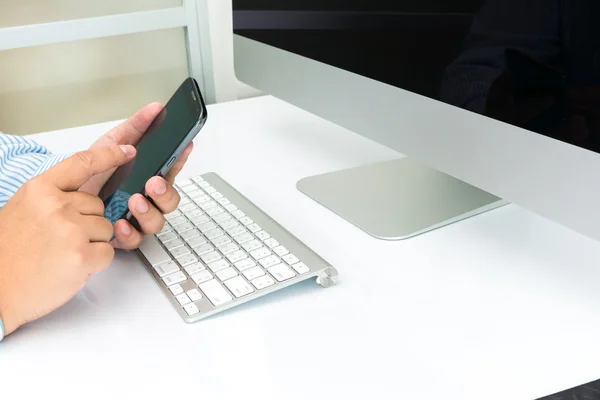 Equipo de negocios con smartphone y teclado a mano — Foto de Stock