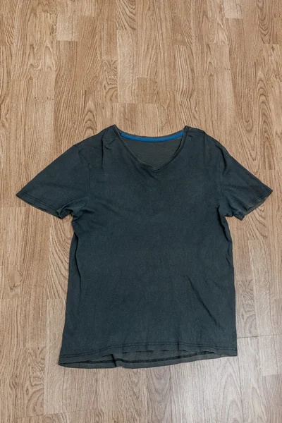 Grey t-shirt on wood background — Stock Photo, Image