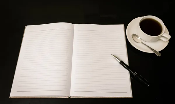 Ανοίξτε ένα κενό σημειωματάριο λευκό, το στυλό και το φλιτζάνι του καφέ — Φωτογραφία Αρχείου