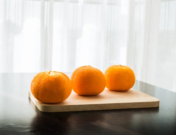 Oranges set on wooden base — Stock Photo, Image