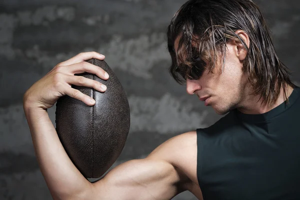 Football player with ball in his arm — Stock Photo, Image