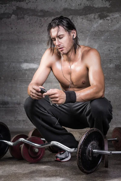 Handsome crouched athlete — Stock Photo, Image