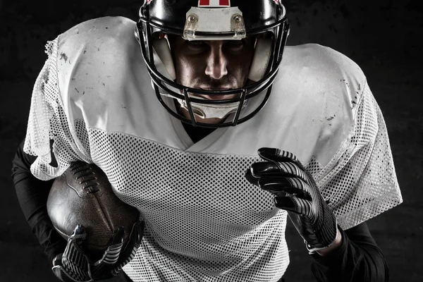 Portrait of american football player holding a ball and running — Stock Photo, Image