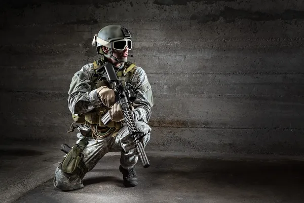 Soldier with mask rifle and backpack Royalty Free Stock Images