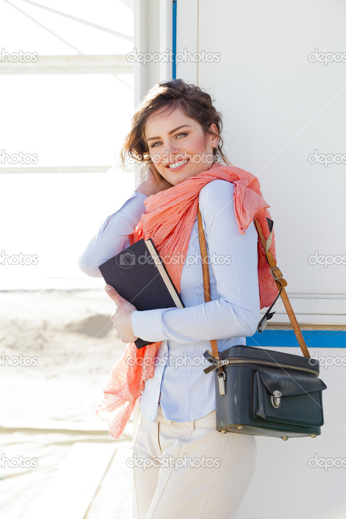 Outdoor Portrait of smiling young tourist woman