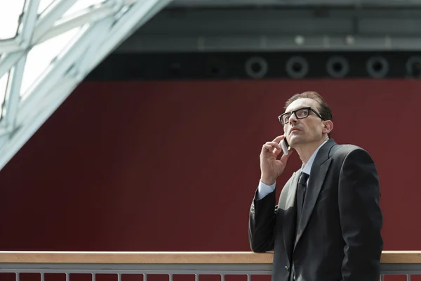 Eyeglasses Pensive Businessman talking on phone — Stock Photo, Image