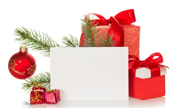 Christmas toys and gifts, fir-tree branch and empty card isolated on white — Stock Photo, Image