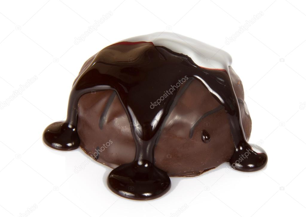 Delightful dark chocolate praline, with streams of the melted chocolate, isolated on white