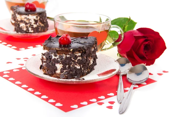 Čokoláda třešňový dorty, horký čaj a červené růže izolovaných na bílém — Stock fotografie