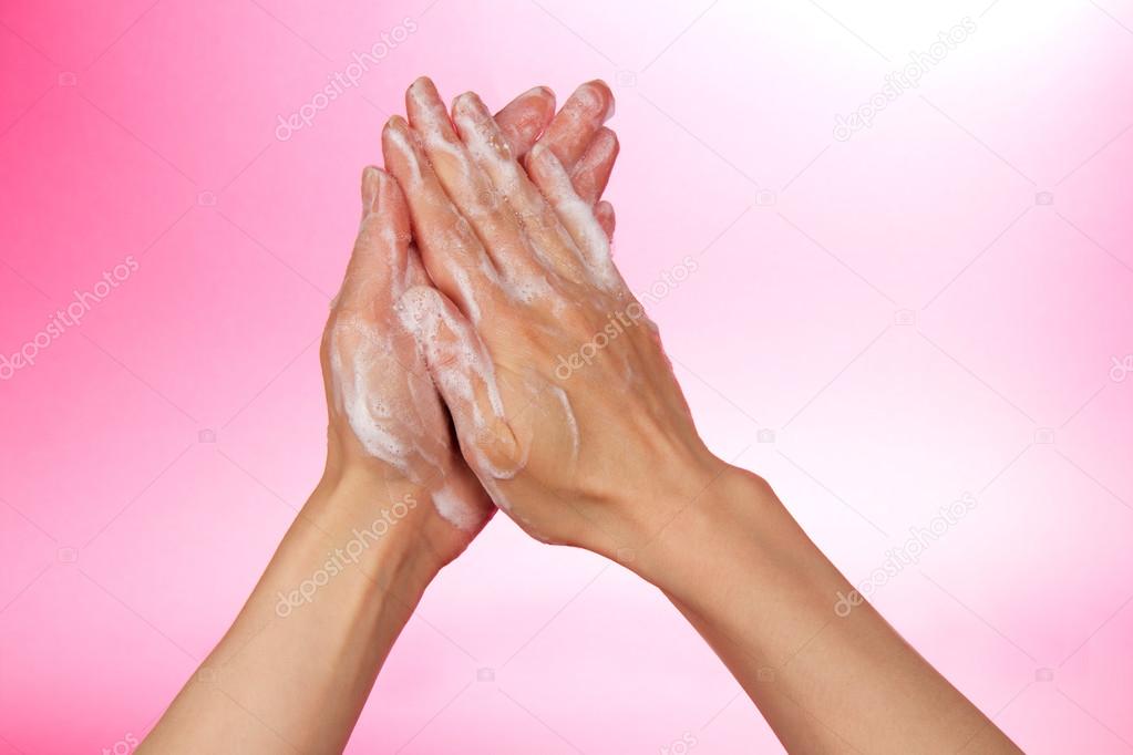 Hands and foam on a pink background