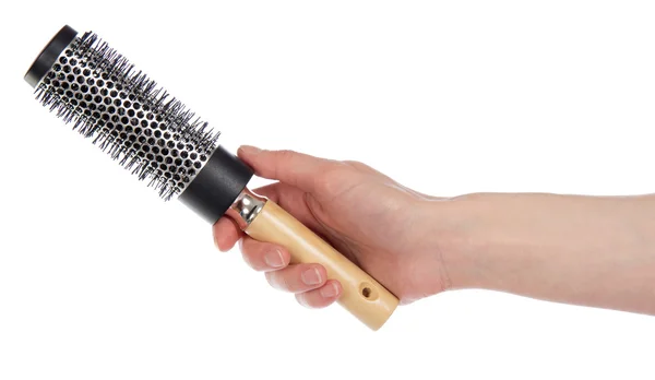 Escova de cabelo com a maçaneta de madeira em uma mão, isolada no branco — Fotografia de Stock