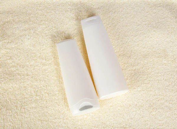 Shampoo and balm on a terry cloth — Stock Photo, Image