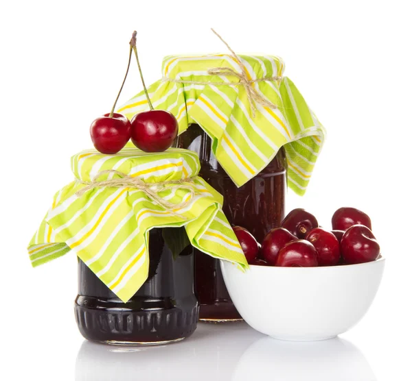Two jars of jam, a cup with sweet cherries — Stock Photo, Image