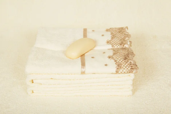 Beautiful towels with an embroidery and soap on a terry cloth — Stock Photo, Image