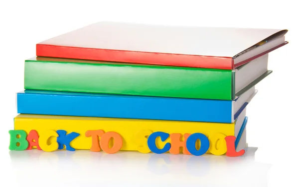 Pilha de livros escolares e as letras de cor de plástico — Fotografia de Stock