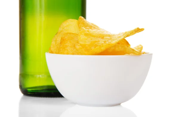 Faience bowl with chips and wet bottle of beer, closeup — Stock Photo, Image