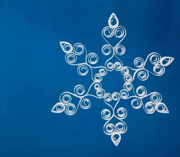 Snowflake applique with quilling on blue background. Stripe paper swirl — Stock Photo, Image
